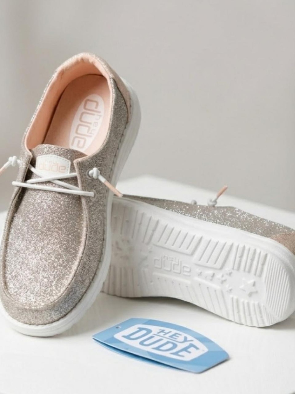 Hey Dude Women’s Glitter Slip-On Sneakers in Metallic Rose